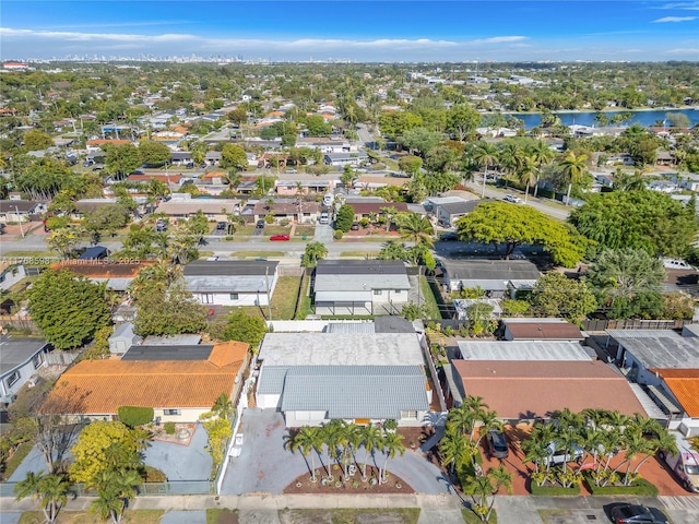 drone / aerial view with a water view and a residential view