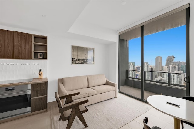 601 NE 1st Ave Unit 4814, Miami, FL 33132 - living area with light tile patterned floors, a view of skyline, and a wall of windows