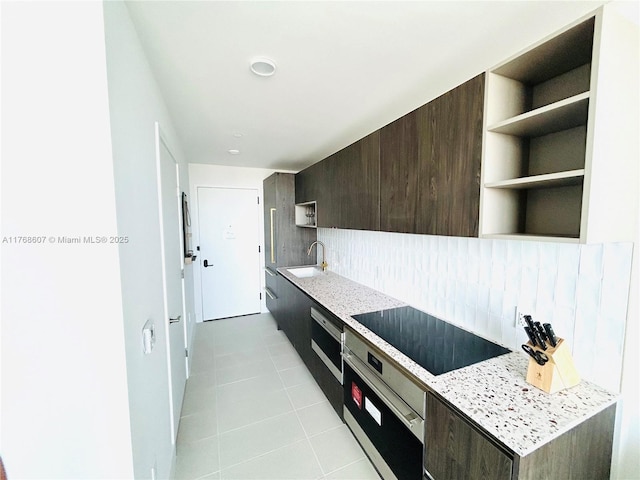 601 NE 1st Ave Unit 4814, Miami, FL 33132 - kitchen with a sink, oven, light countertops, black electric stovetop, and tasteful backsplash
