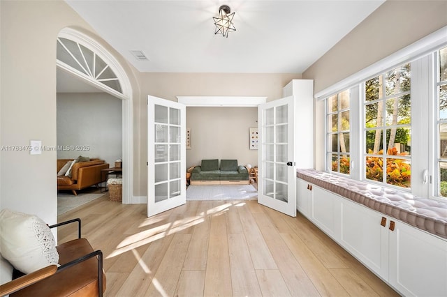 interior space with french doors and visible vents