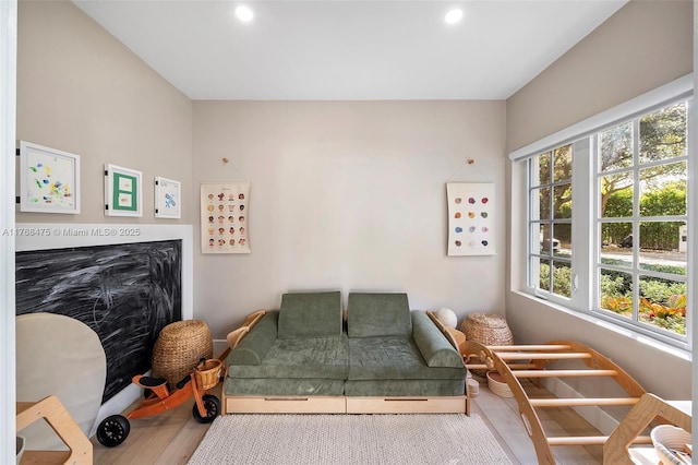 living room with recessed lighting, a healthy amount of sunlight, and wood finished floors