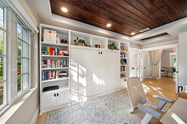 home office featuring light wood-type flooring, wooden ceiling, and a raised ceiling