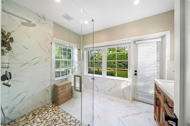 full bath with stone wall, marble finish floor, a marble finish shower, and visible vents