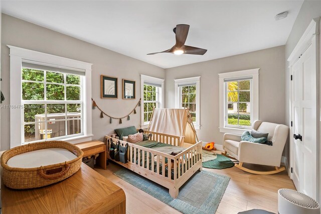 bedroom with light wood-type flooring and ceiling fan