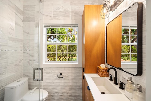 full bathroom with toilet, a stall shower, tile walls, and a wealth of natural light