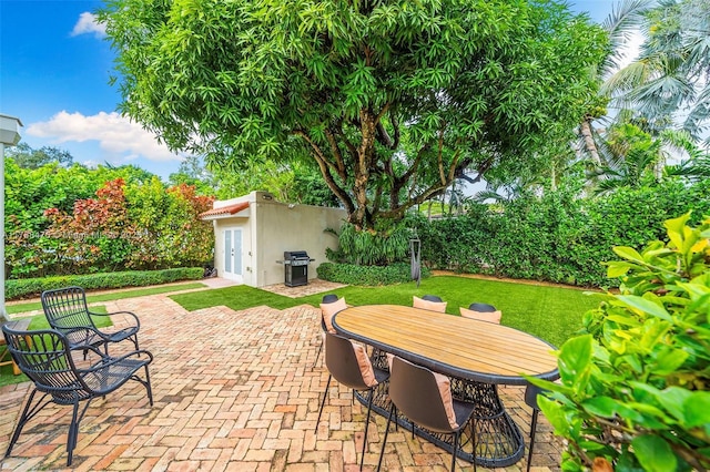 view of patio featuring grilling area and an outdoor structure