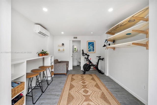workout area featuring recessed lighting, visible vents, wood finish floors, and an AC wall unit