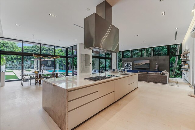 4780 SW 86th Ter, Miami, FL 33143 - kitchen with stainless steel gas stovetop, floor to ceiling windows, island range hood, modern cabinets, and a sink