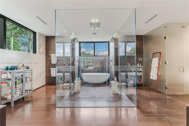 4780 SW 86th Ter, Miami, FL 33143 - bathroom with visible vents, a freestanding bath, and expansive windows