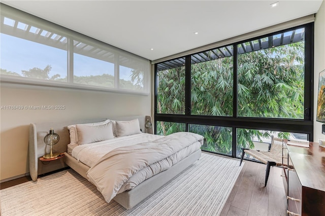 4780 SW 86th Ter, Miami, FL 33143 - bedroom with a wall of windows and hardwood / wood-style flooring