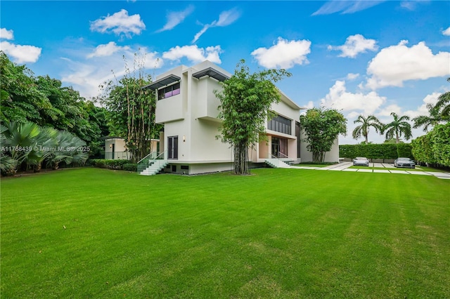 4780 SW 86th Ter, Miami, FL 33143 - back of property featuring entry steps, a lawn, and stucco siding