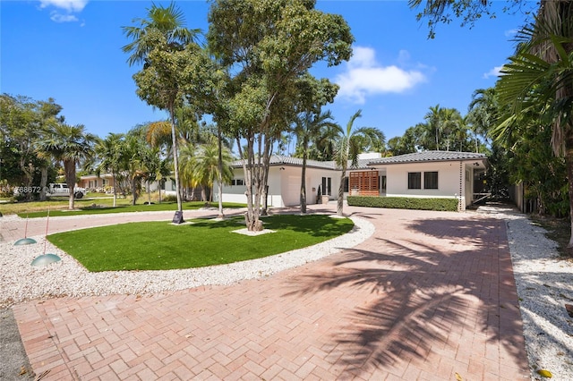 1221 NE 87th St, Miami, FL 33138 - view of front facade featuring a tiled roof, a front yard, and stucco siding