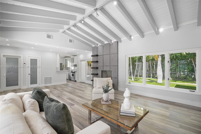 1221 NE 87th St, Miami, FL 33138 - living room featuring visible vents, light wood-style floors, and beamed ceiling