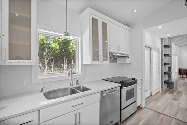 1221 NE 87th St, Miami, FL 33138 - kitchen with dishwasher, under cabinet range hood, white cabinets, a sink, and range