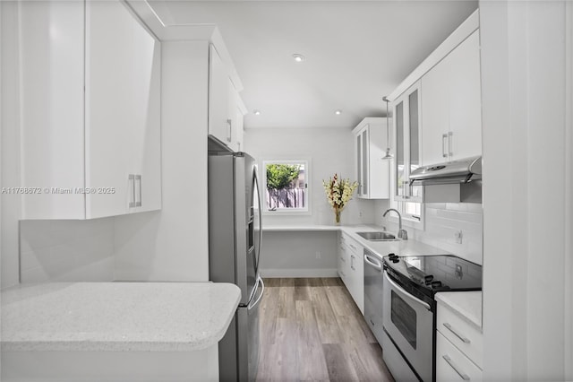 1221 NE 87th St, Miami, FL 33138 - kitchen featuring a sink, stainless steel appliances, white cabinetry, and under cabinet range hood