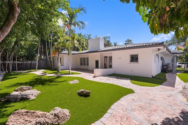 1221 NE 87th St, Miami, FL 33138 - rear view of property with a lawn, stucco siding, a tile roof, and fence