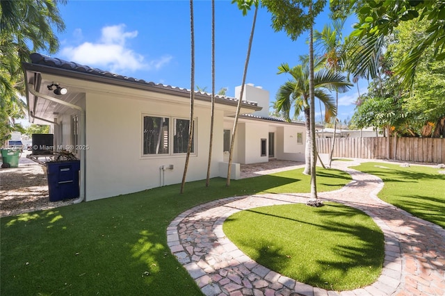 1221 NE 87th St, Miami, FL 33138 - back of property featuring fence, cooling unit, stucco siding, a tiled roof, and a yard