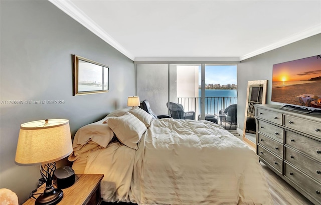 bedroom with light wood-style flooring, crown molding, and access to outside
