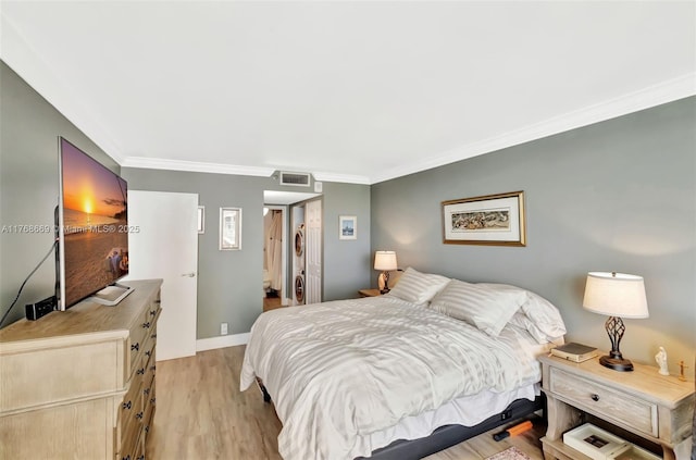 bedroom with ornamental molding, baseboards, light wood finished floors, and visible vents