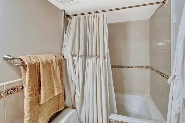 bathroom with visible vents, toilet, and shower / bathtub combination with curtain