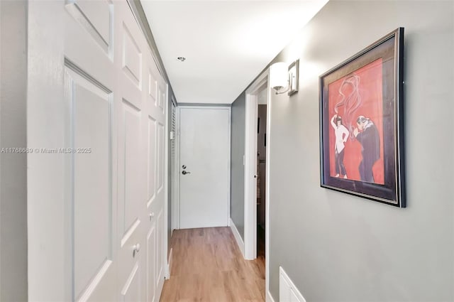 corridor featuring light wood finished floors and visible vents