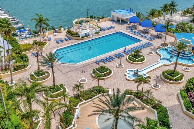 view of pool with a water view and a patio area