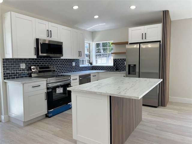 kitchen featuring a sink, stainless steel appliances, backsplash, and open shelves
