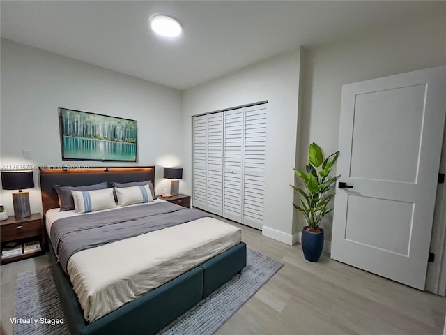 bedroom with baseboards and wood finished floors