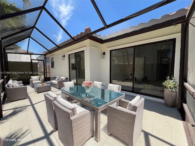 view of patio / terrace with an outdoor living space with a fire pit and a lanai