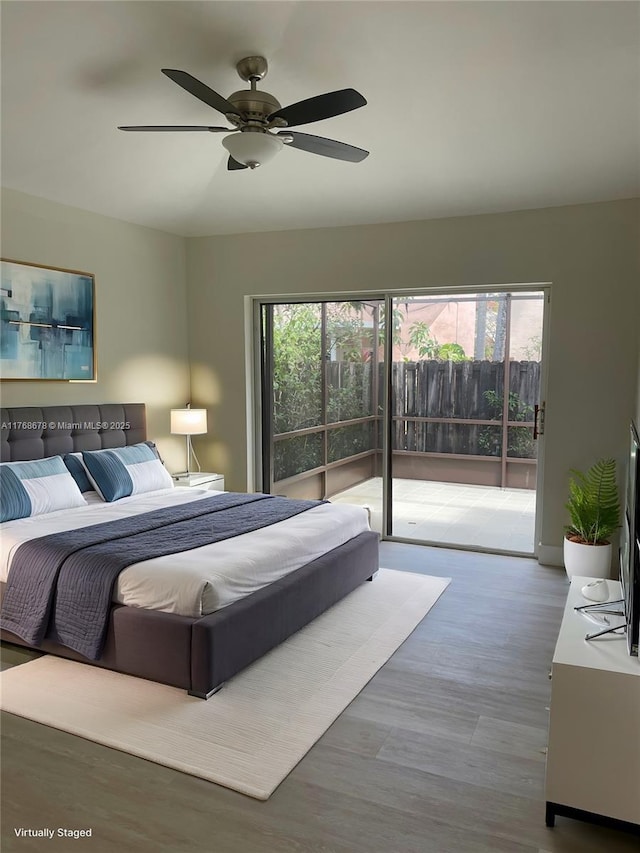 bedroom featuring access to exterior, ceiling fan, and wood finished floors