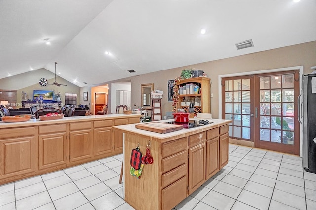 kitchen with visible vents, a kitchen island, lofted ceiling, french doors, and open floor plan
