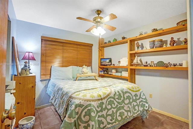 tiled bedroom featuring baseboards and ceiling fan