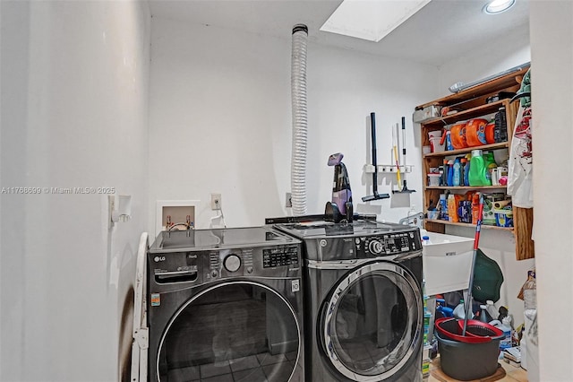 laundry room with laundry area, a skylight, independent washer and dryer, and a sink
