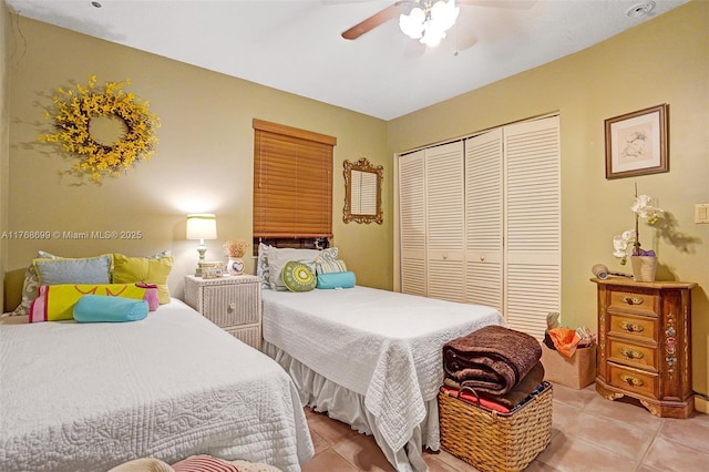 bedroom featuring a closet, ceiling fan, and light tile patterned flooring