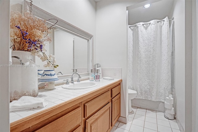 bathroom featuring tile patterned floors, shower / bath combo with shower curtain, toilet, and vanity