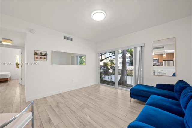 740 Meridian Ave Unit 11, Miami Beach, FL 33139 - living area featuring light wood-type flooring and baseboards