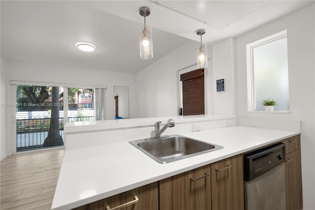 740 Meridian Ave Unit 11, Miami Beach, FL 33139 - kitchen featuring dishwasher, a sink, light countertops, pendant lighting, and light wood-style floors