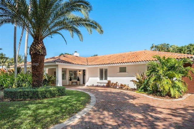 13453 SW 58th Ave, Pinecrest, FL 33156 - mediterranean / spanish-style house featuring stucco siding, a tile roof, and a chimney