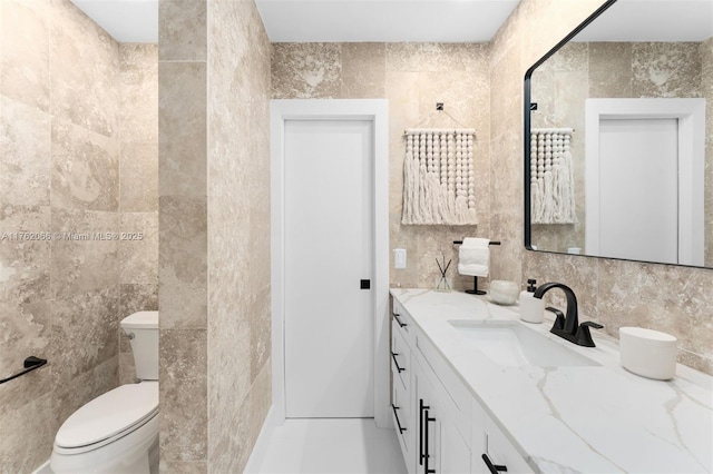 13453 SW 58th Ave, Pinecrest, FL 33156 - bathroom featuring tile walls, vanity, and tasteful backsplash