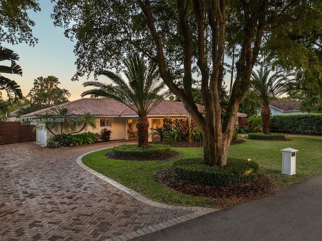 13453 SW 58th Ave, Pinecrest, FL 33156 - ranch-style home with decorative driveway, a front yard, an attached garage, a tile roof, and stucco siding