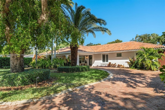 13453 SW 58th Ave, Pinecrest, FL 33156 - ranch-style home with a tiled roof, stucco siding, decorative driveway, and a front lawn