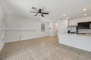 unfurnished living room featuring light tile patterned floors, recessed lighting, and a ceiling fan