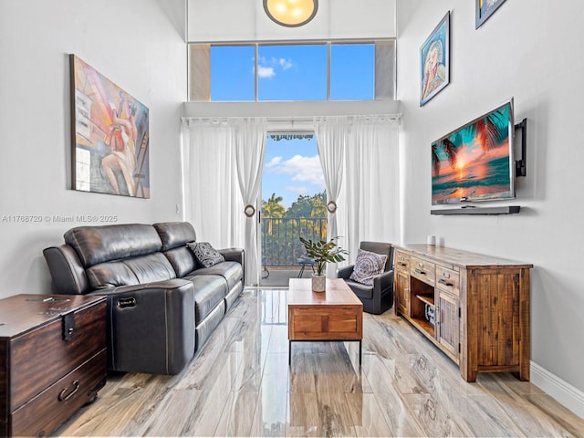 820 NW 87th Ave Unit 409, Miami, FL 33172 - living room with baseboards and a high ceiling