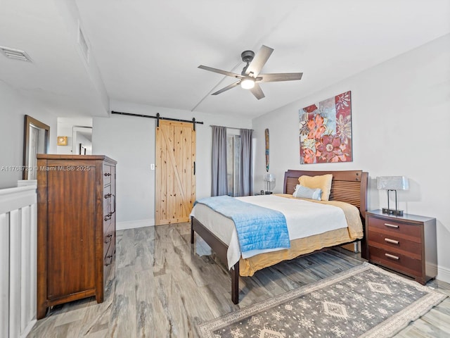 820 NW 87th Ave Unit 409, Miami, FL 33172 - bedroom with baseboards, visible vents, light wood-style flooring, ceiling fan, and a barn door