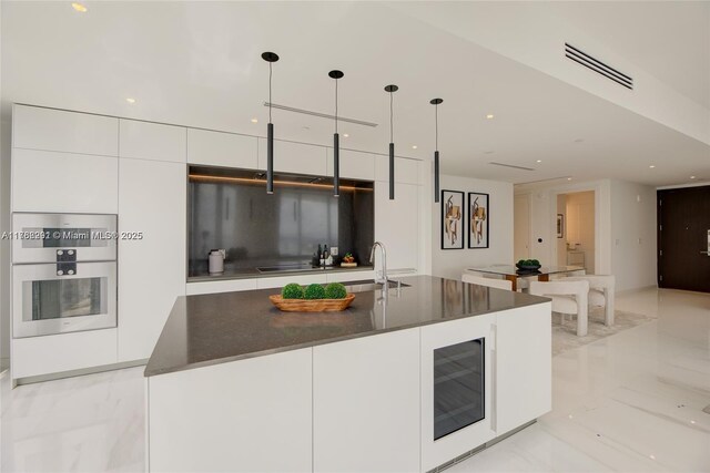 300 Biscayne Blvd Way Unit 3707, Miami, FL 33131 - kitchen with visible vents, marble finish floor, modern cabinets, beverage cooler, and white cabinetry