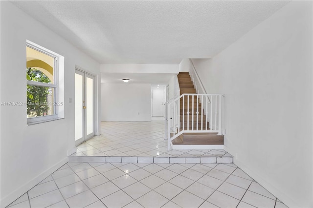 3524 NW 4th Ter, Miami, FL 33125 - interior space featuring light tile patterned floors, a textured ceiling, and stairs