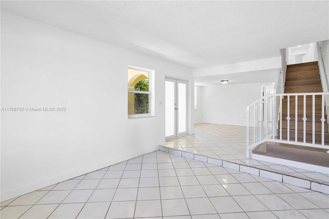 3524 NW 4th Ter, Miami, FL 33125 - empty room with stairs, light tile patterned floors, and a textured ceiling