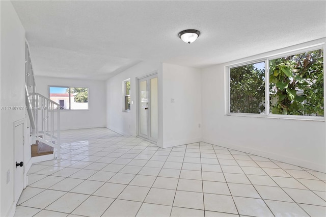 3524 NW 4th Ter, Miami, FL 33125 - spare room featuring light tile patterned floors and a textured ceiling