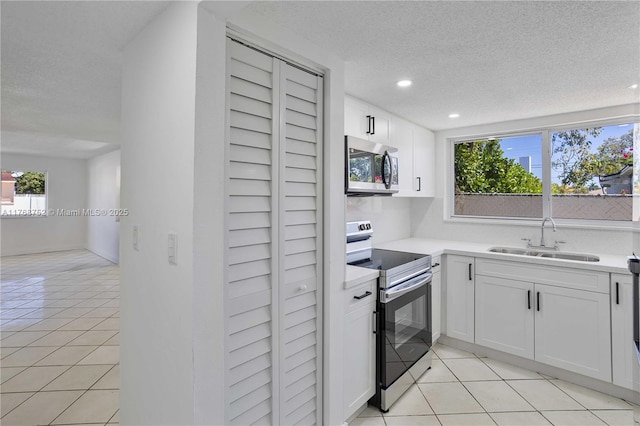 3524 NW 4th Ter, Miami, FL 33125 - kitchen featuring light tile patterned floors, stainless steel appliances, light countertops, and a sink