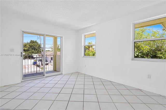 3524 NW 4th Ter, Miami, FL 33125 - unfurnished room with light tile patterned floors and a textured ceiling